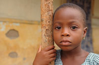 Little girl leaning on pole